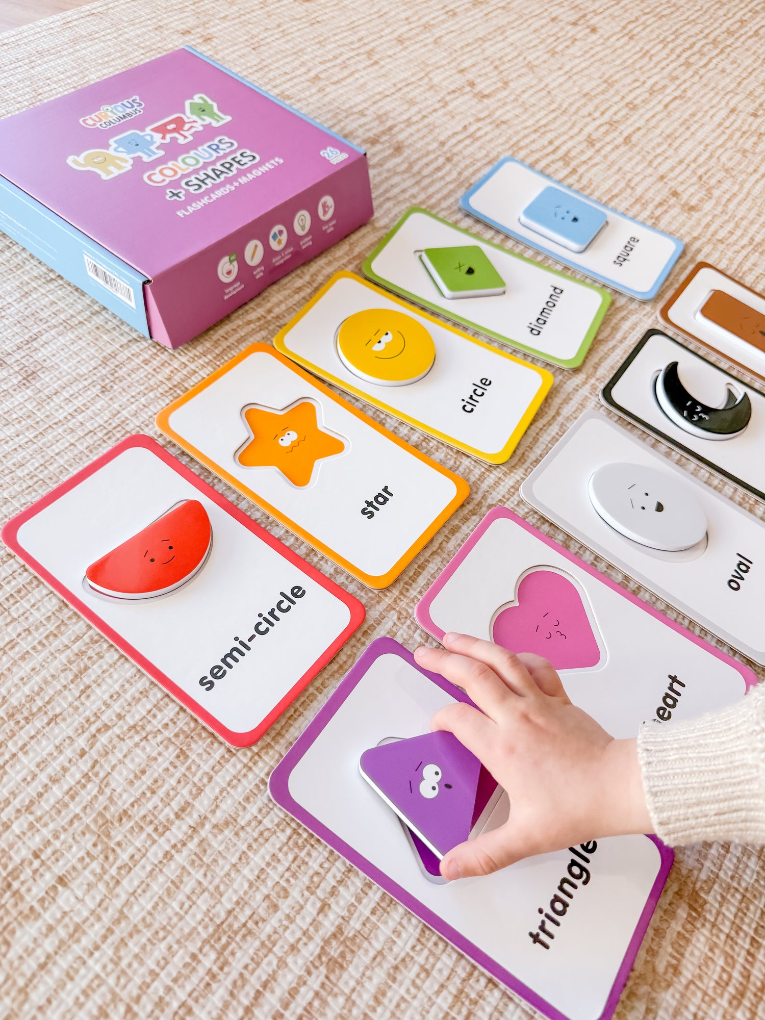 Educational card game with colorful cards on a textured surface